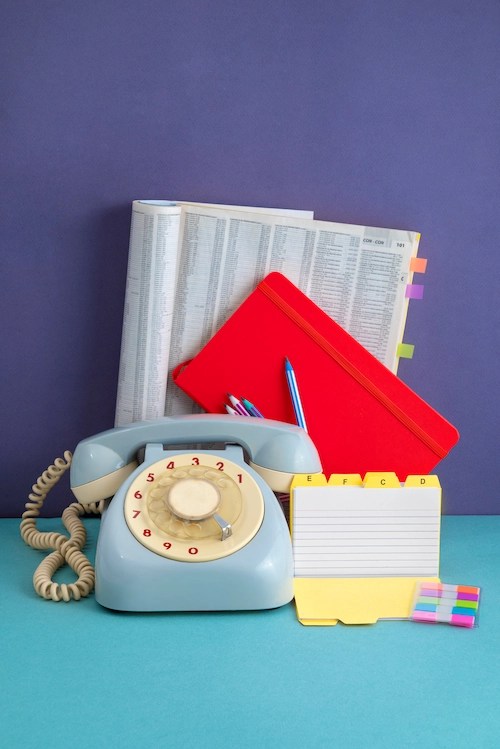 Phonebook and an old telephone assortment